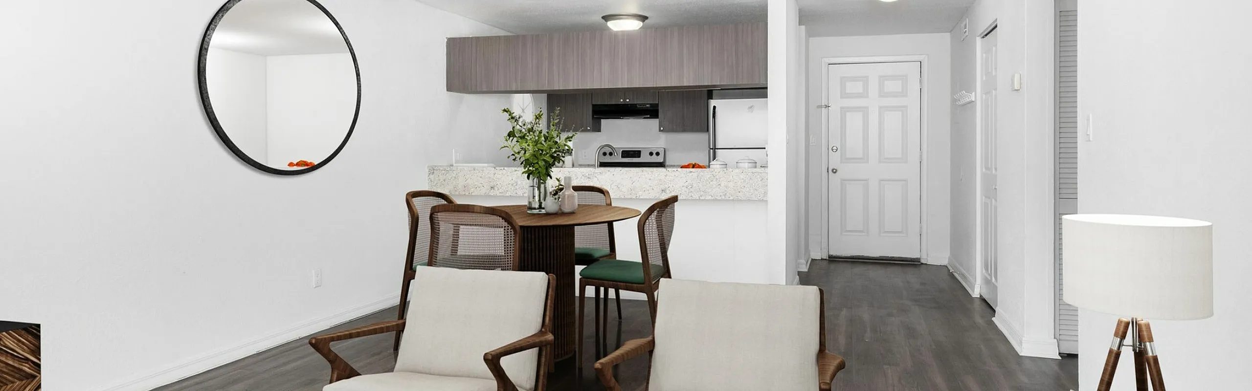 Chic open-plan living room featuring a modern kitchen with elegant dining space, stylish furnishings, and artistic decor.