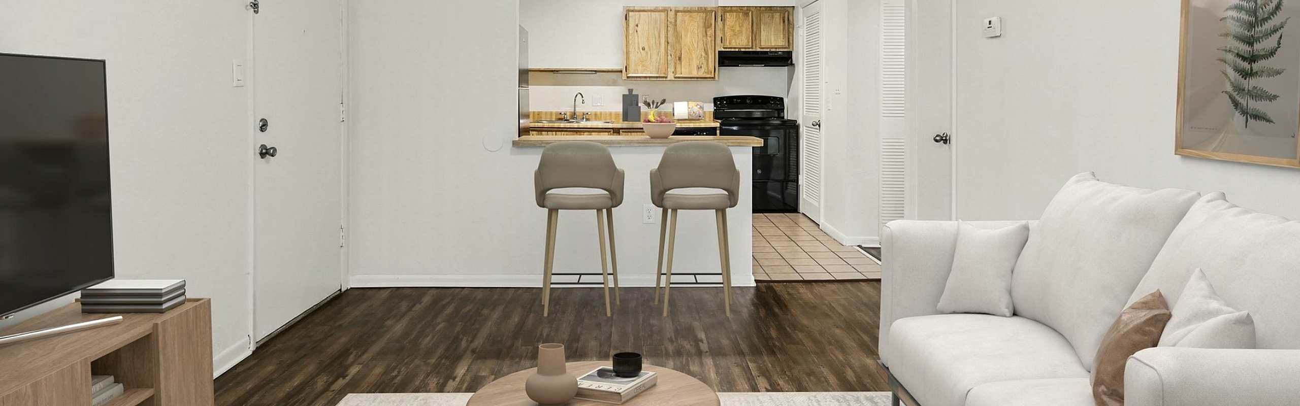 Inviting living space with chic decor, cozy sofa, and a sleek open kitchen perfect for modern living.