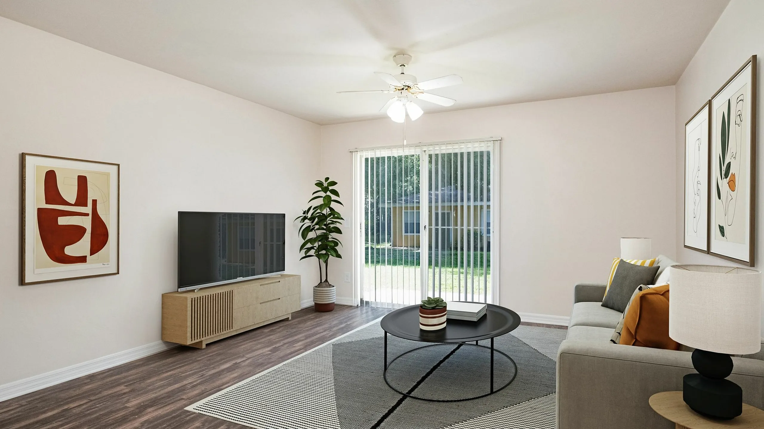 Bright and modern living room with sleek decor, featuring a cozy sofa, stylish round coffee table, and large sliding glass doors opening to lush greenery.