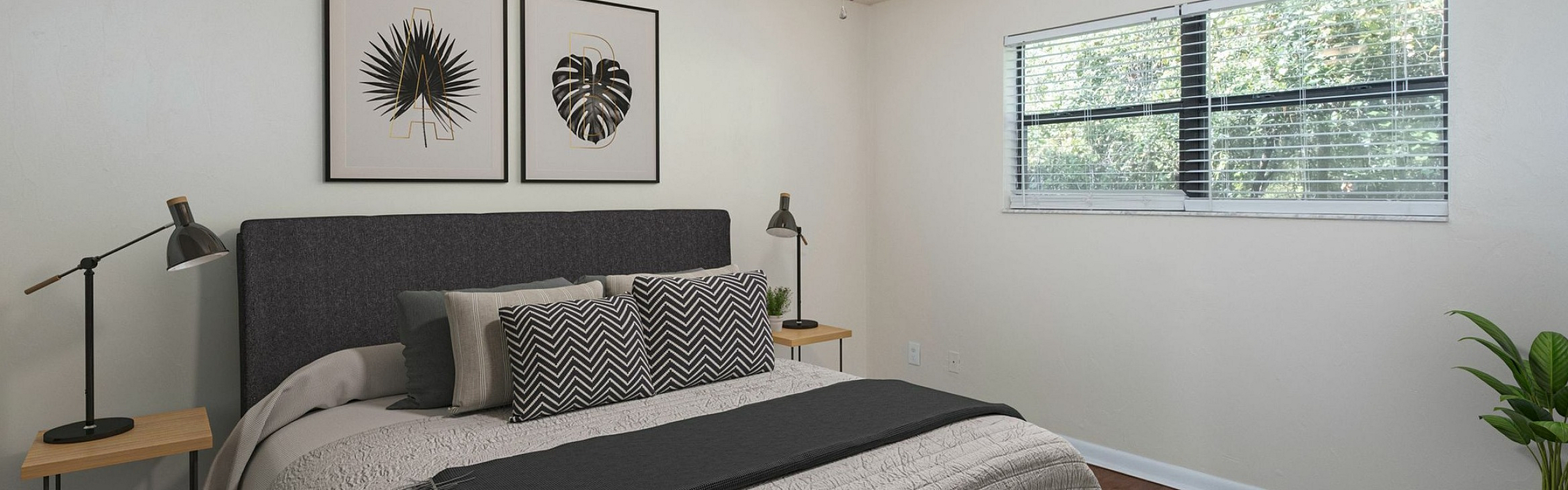 Inviting bedroom with plush bedding, modern artwork, and a cozy ambiance, complete with natural light and elegant decor.