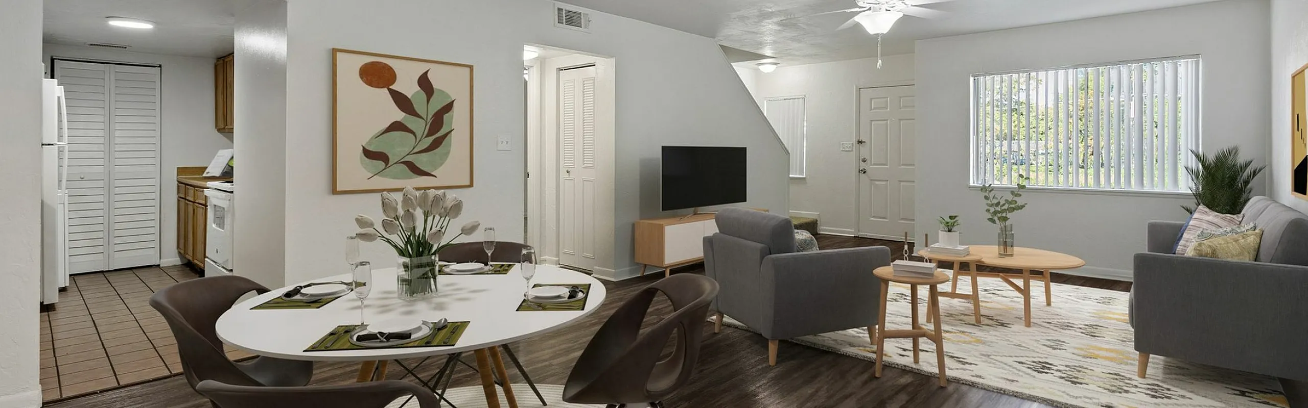 Contemporary living area with sleek dining set, cozy seating, and open transition to the modern kitchen, showcasing elegant interior design and natural light.