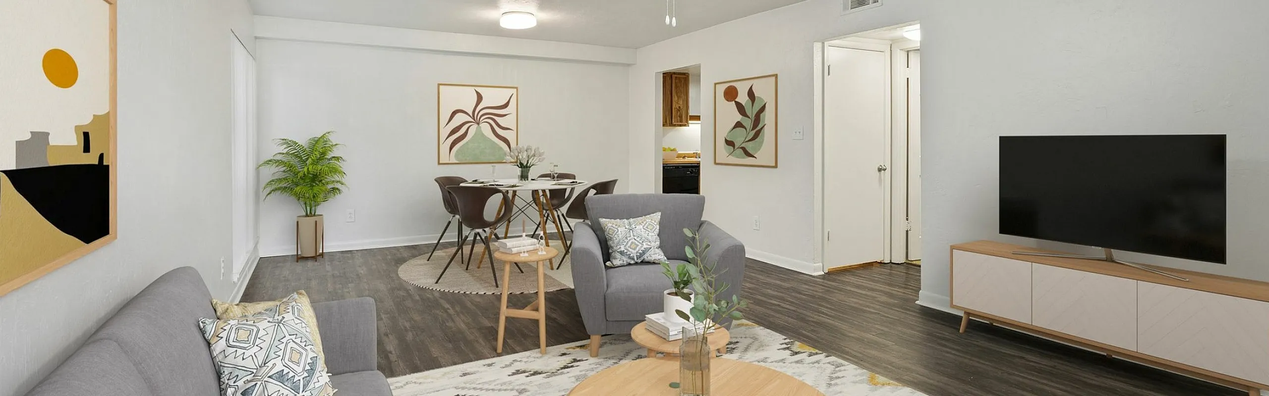 Inviting open-concept living room with modern decor, cozy seating, elegant dining area, and stylish art pieces, perfect for relaxation.