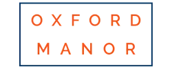 Elegant Oxford Manor logo with bold orange lettering on a sleek white background.