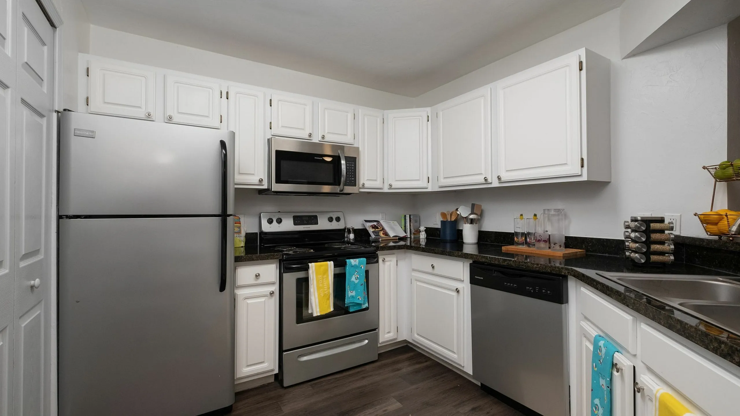 Modern kitchen with sleek stainless steel appliances, white cabinetry, and a spacious layout perfect for gourmet cooking.