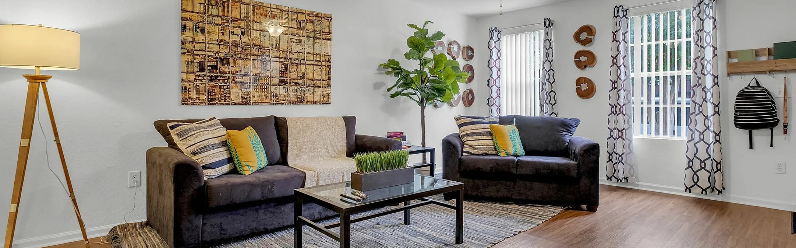 Inviting living room with stylish decor, featuring plush sofas, wooden flooring, and abundant natural light.