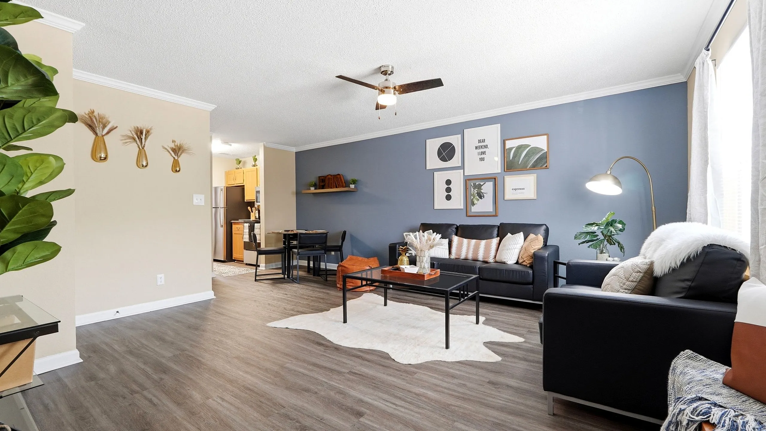 Chic living room with modern decor, featuring cozy seating, stylish accent wall, and natural light enhancing the elegant design.