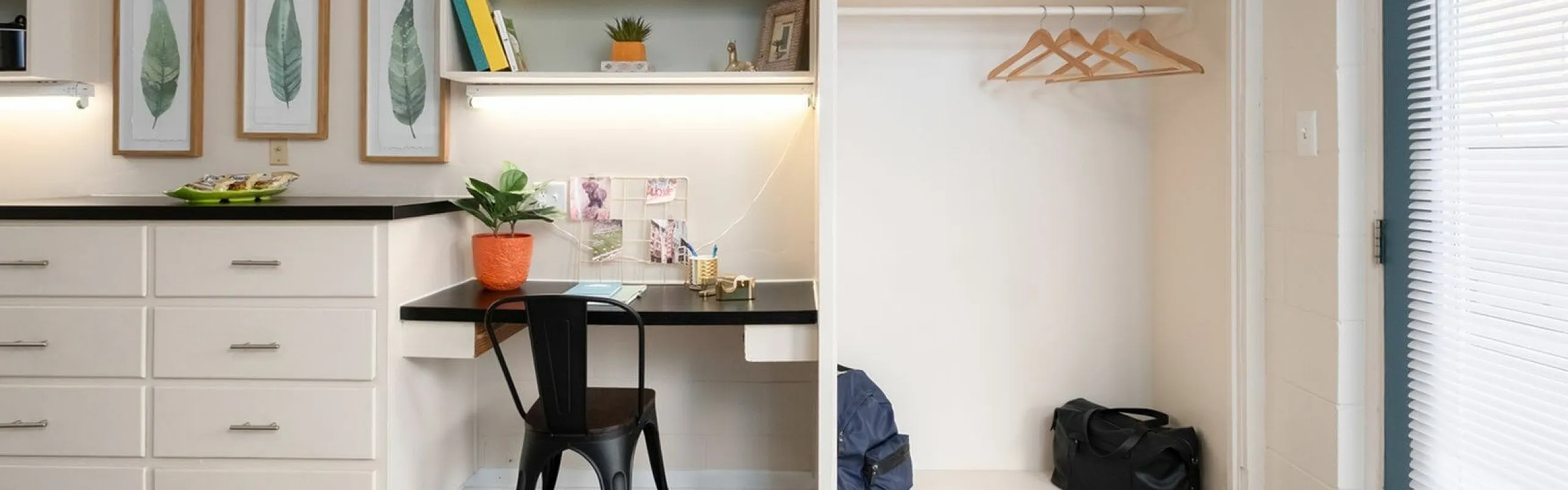 Chic and functional workspace with built-in shelving, vibrant decor, and ample storage in a modern apartment.