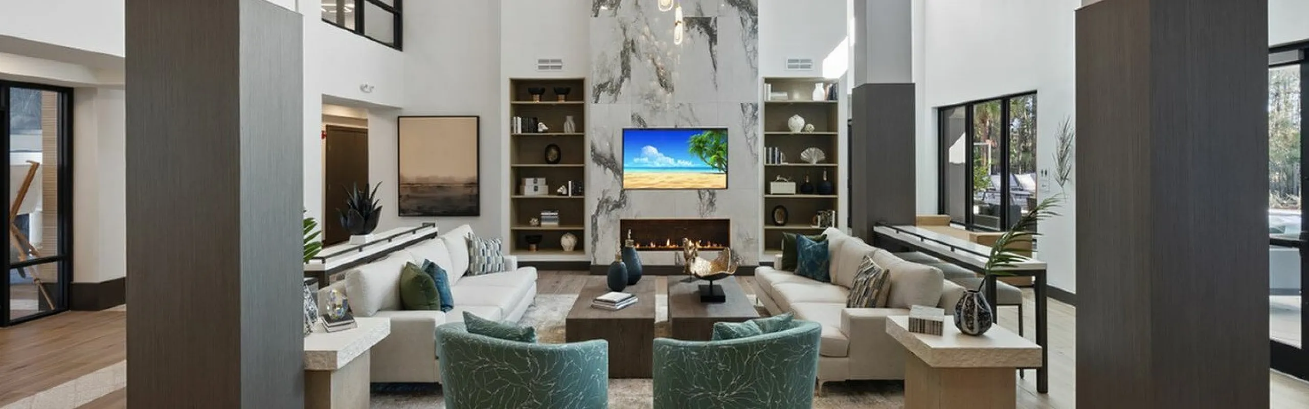 Elegant modern lounge with high ceilings, stylish furnishings, and a luxurious fireplace, ideal for relaxation and gatherings.