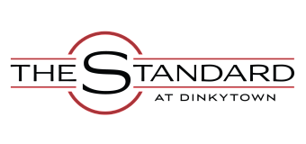 Sophisticated logo for The Standard at Dinkytown, featuring bold black text and a sleek, modern design with red accents.