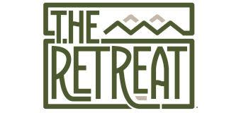 Chic and modern logo for The Retreat, featuring stylized mountain peaks and bold lettering.