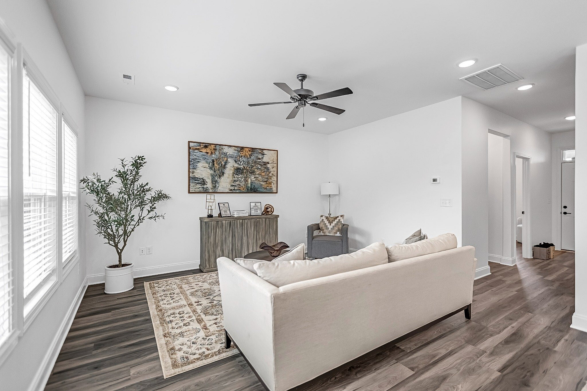 Chic and inviting living room with modern decor, featuring a comfortable sofa, stylish artwork, and abundant natural light.
