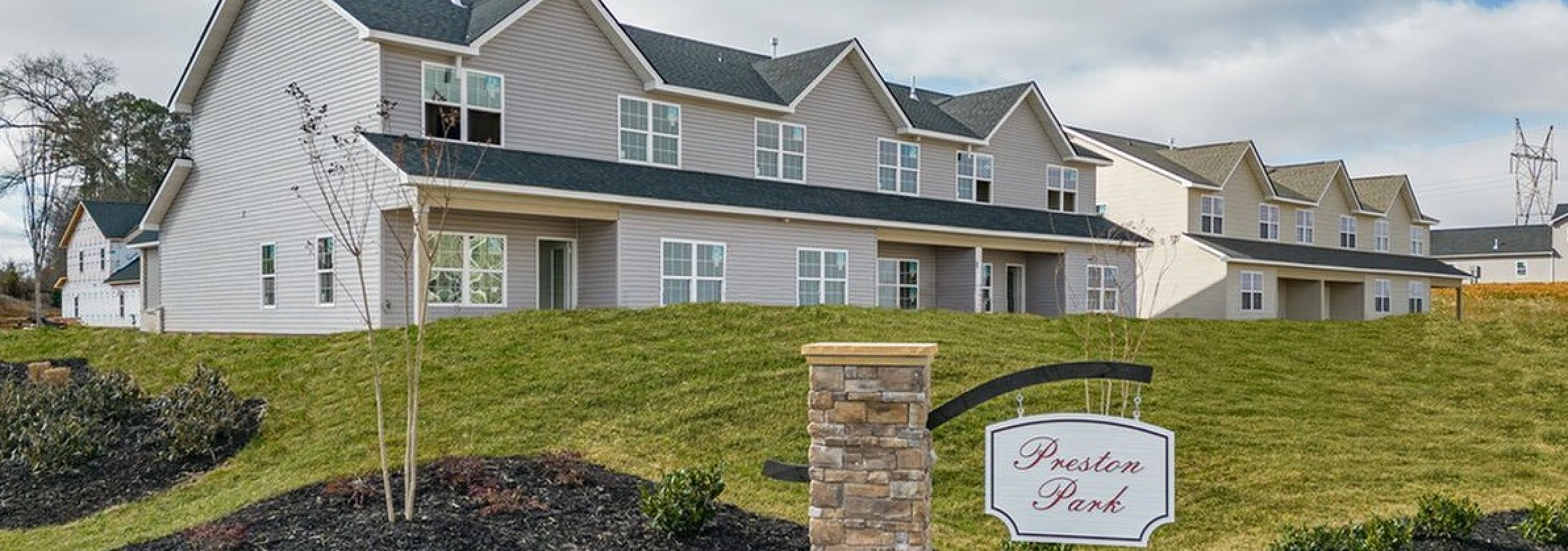 Charming townhouse community at Preston Park with modern architecture, manicured landscaping, and a welcoming ambiance.