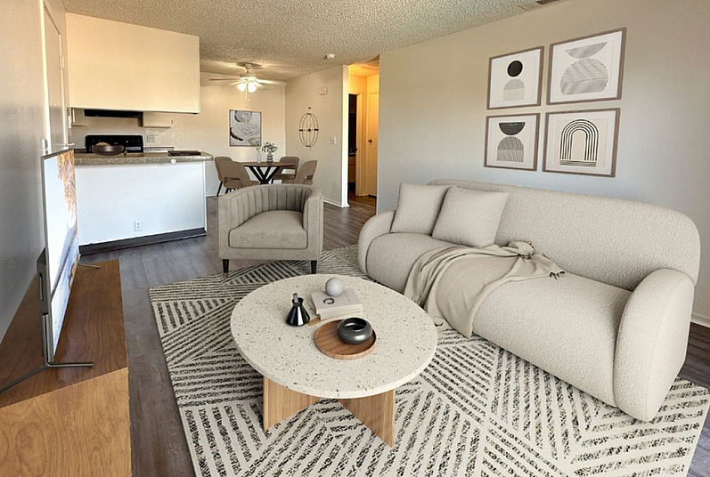 Inviting open-concept living room with modern decor, elegant furnishings, and a seamless flow to the kitchen and dining area.
