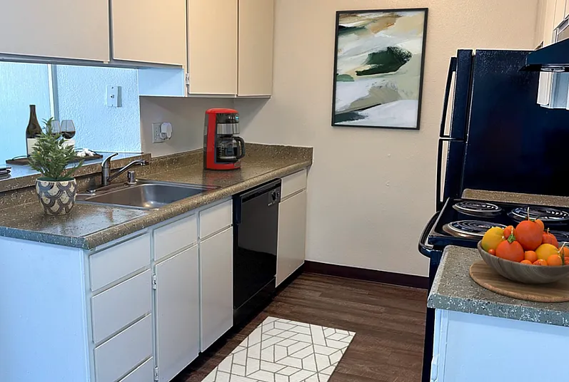 Charming kitchen with modern appliances, elegant countertops, and stylish artwork, offering a cozy, inviting atmosphere.