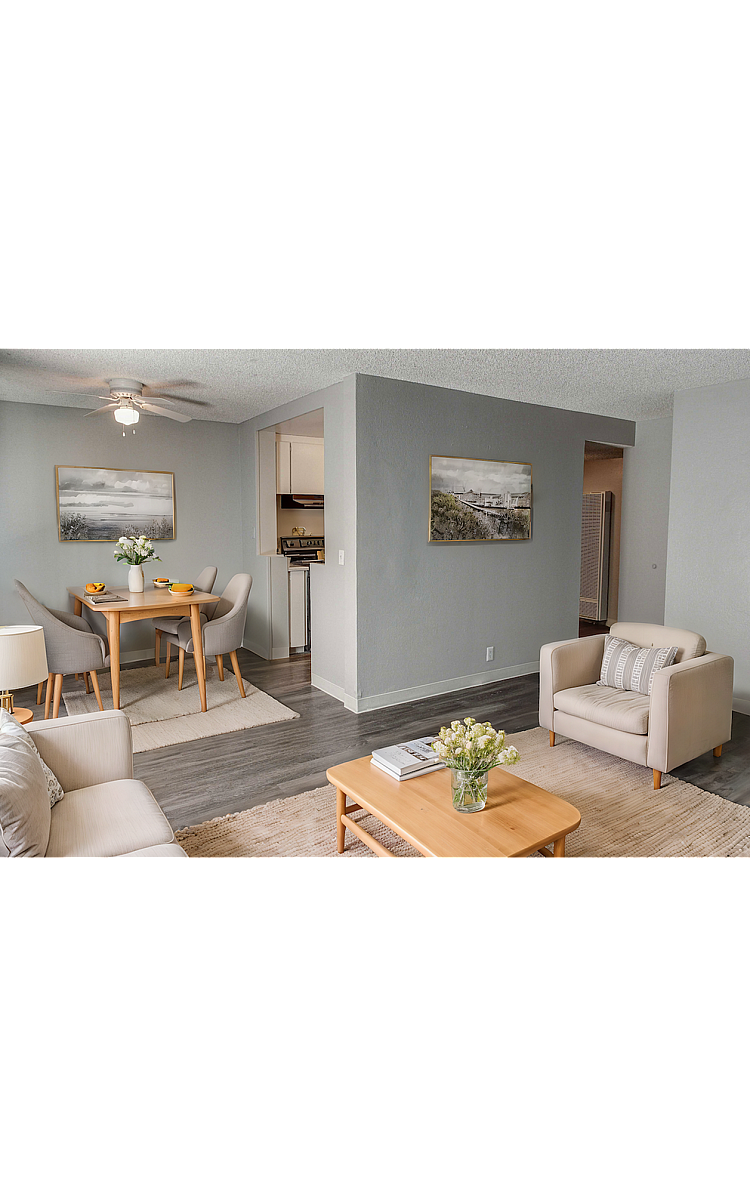 Charming living and dining area with modern decor, cozy seating, and elegant artwork, ideal for comfortable living.