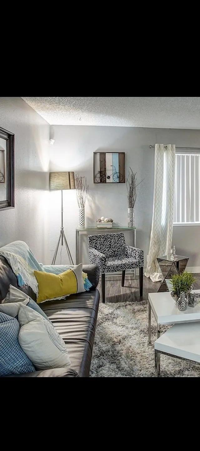 Chic apartment interior with sleek hardwood floors, cozy seating area, and elegant dining space bathed in natural light.