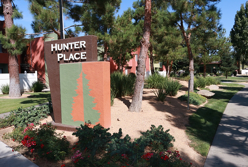 Inviting outdoor view of Hunter Place with lush greenery and vibrant flowers, perfect for nature enthusiasts.