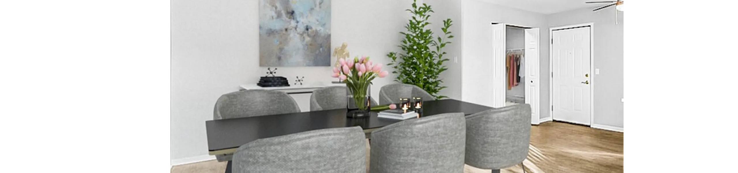 Contemporary dining room with a sleek black table, stylish grey chairs, and vibrant decor.