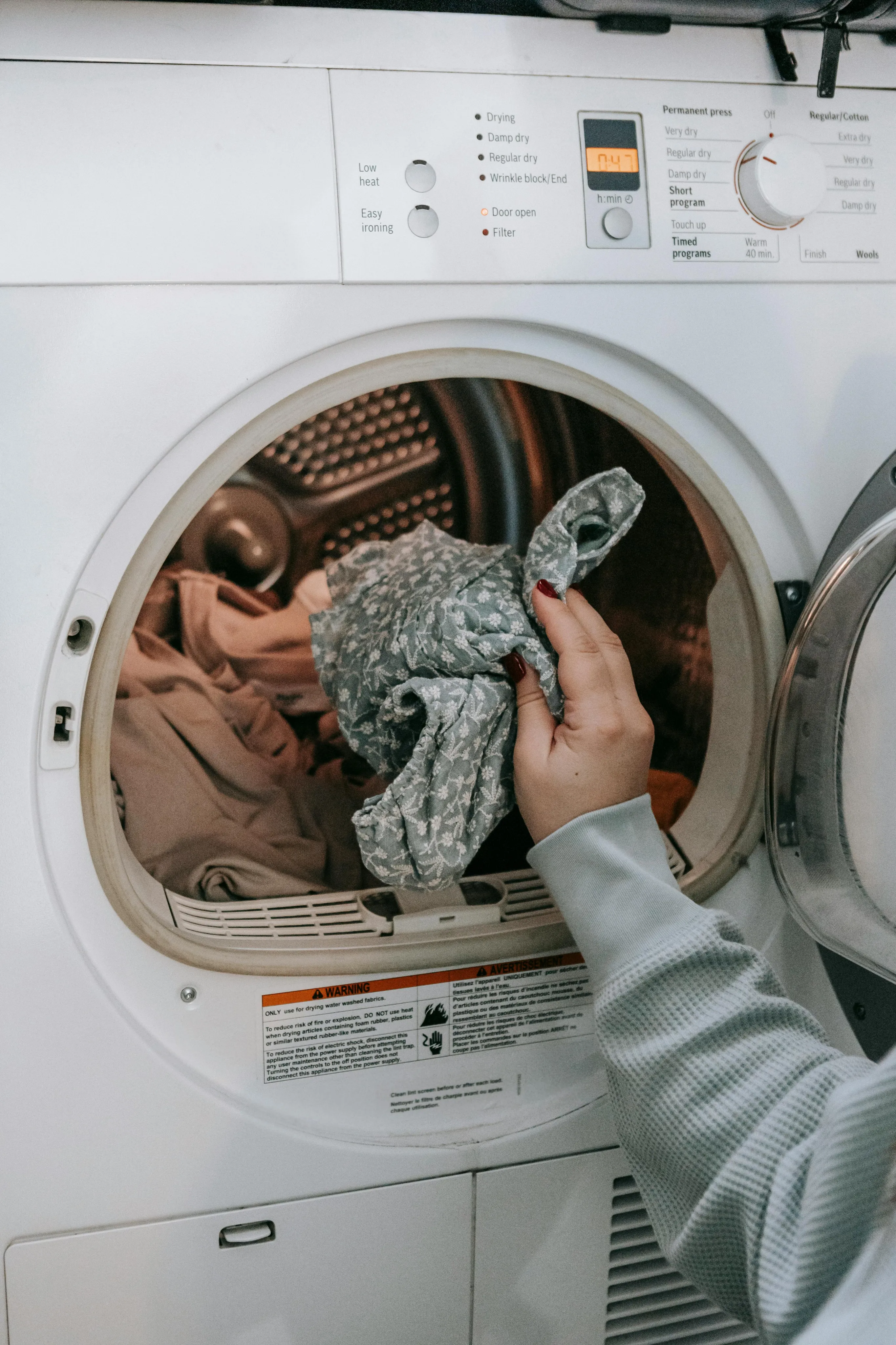 Modern laundry room featuring a high-efficiency dryer with user-friendly controls, perfect for quick and easy laundry care.