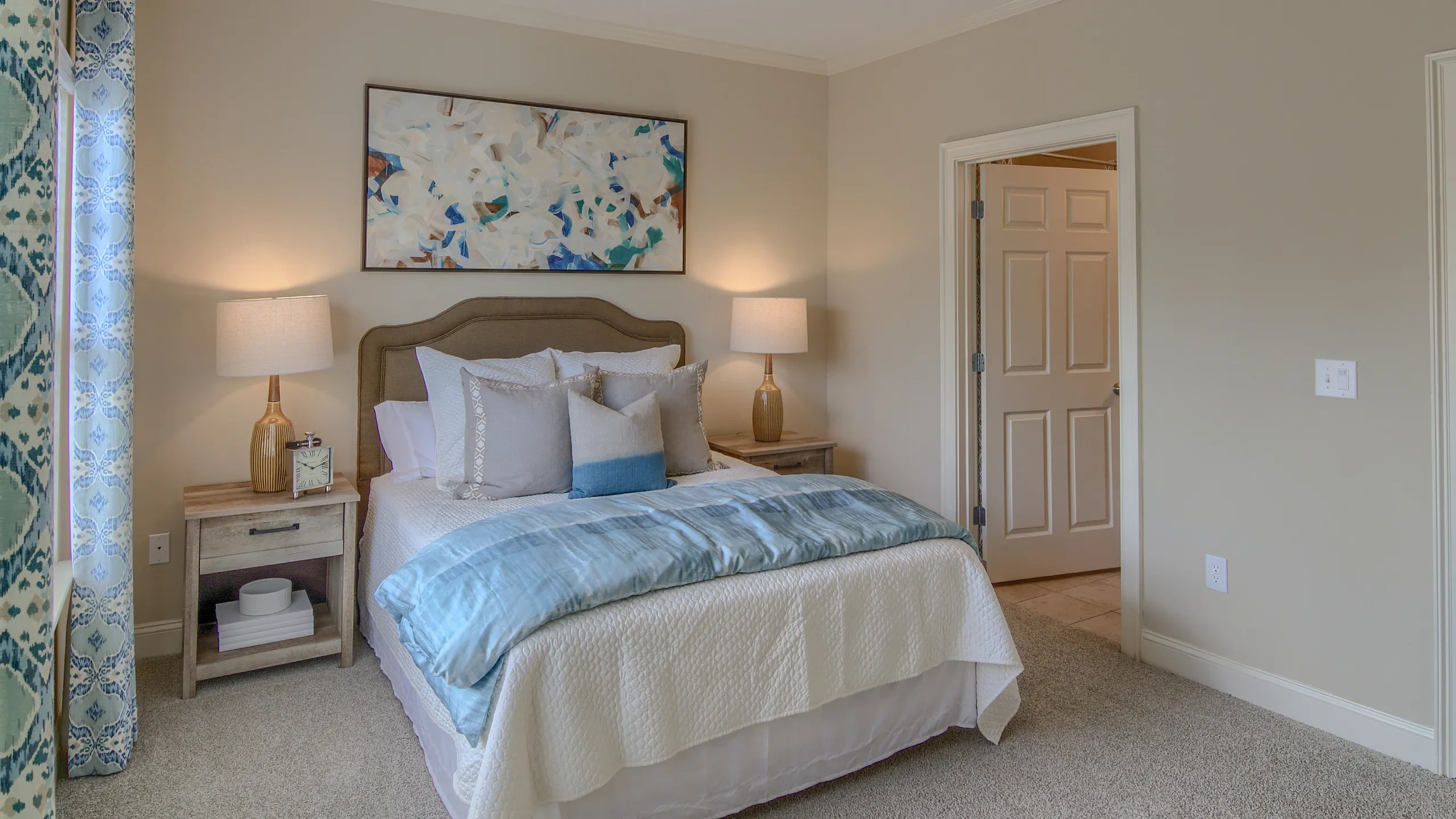 Luxurious bedroom with a comfortable bed, stylish decor, and soothing ambient lighting.