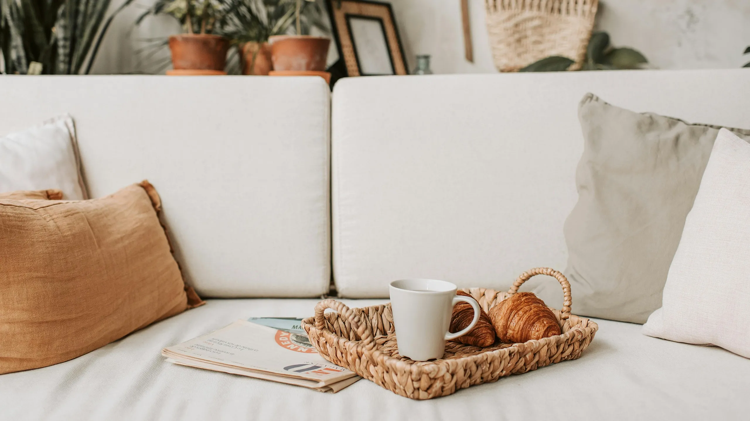 Inviting living space with cozy cushions, stylish decor, and a tranquil greenery backdrop, perfect for relaxation.