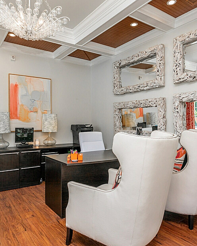 Luxurious leasing office with elegant chandeliers, modern furniture, and artistic decor creating a welcoming atmosphere.