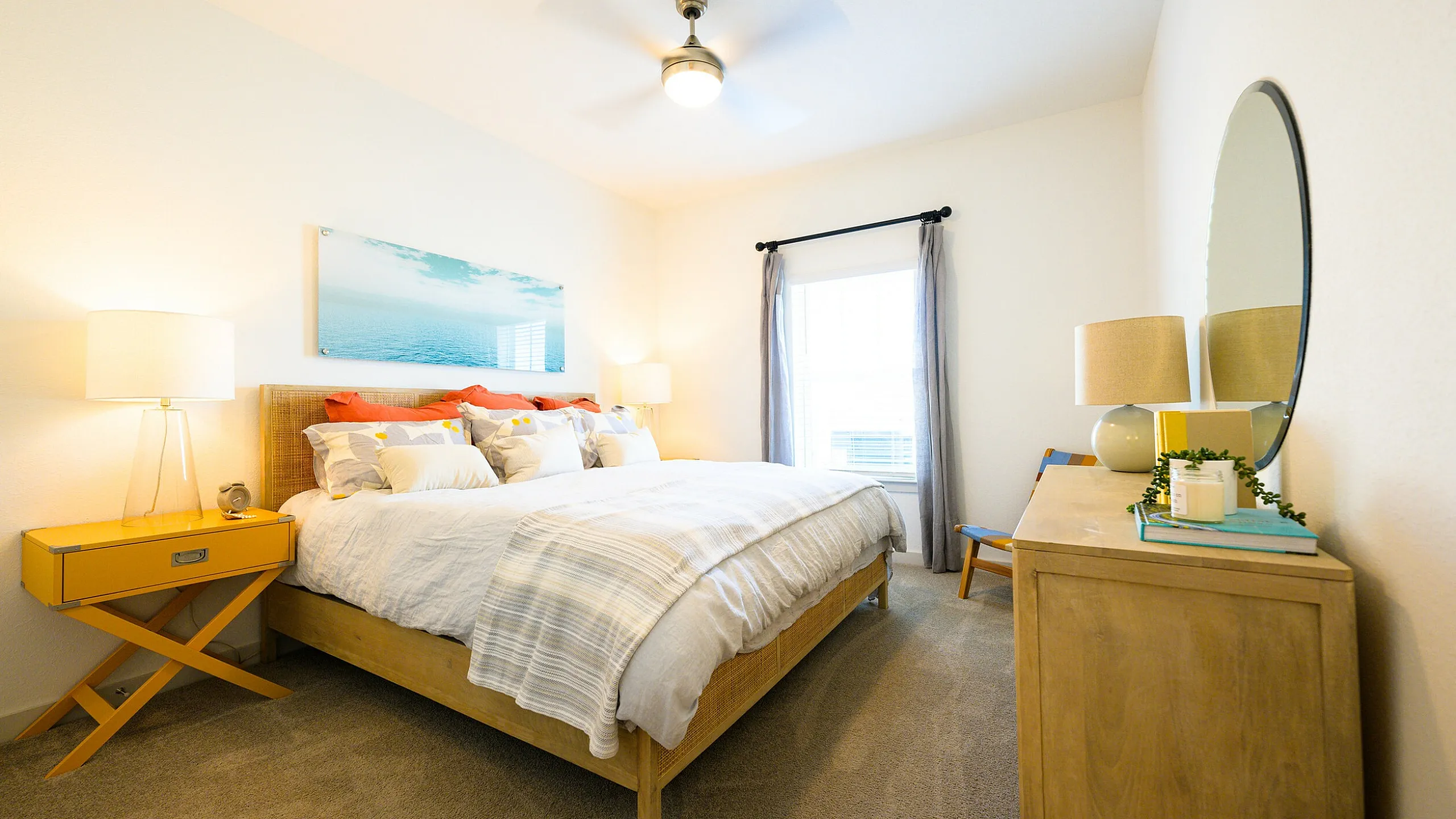 Inviting bedroom with cozy king-size bed, elegant decor, and abundant natural light through a large window.