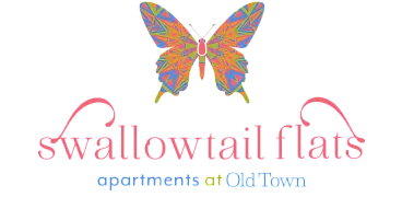 Vibrant butterfly-themed logo for Swallowtail Flats apartments at Old Town, featuring colorful geometric patterns.