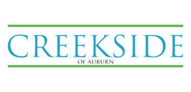 Modern logo displaying 'Creekside of Auburn' in elegant blue and green typography.