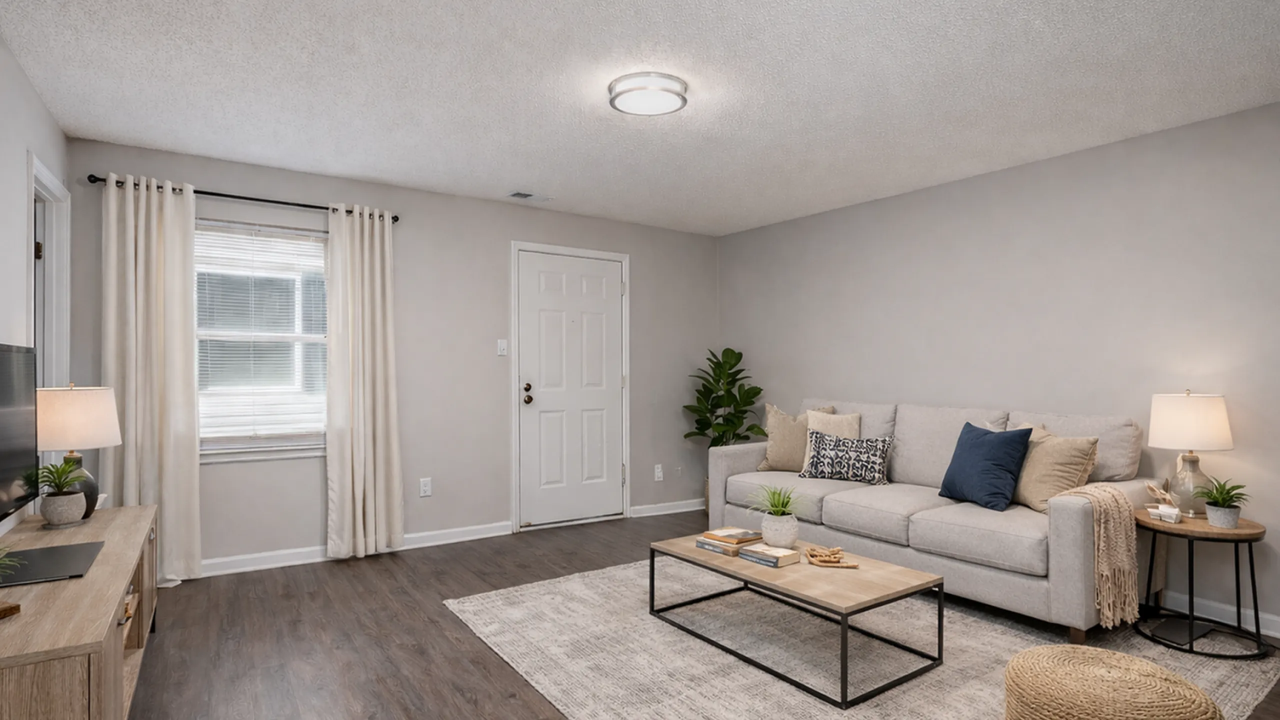 Charming living room with cozy gray sofa, stylish coffee table, and elegant lighting, inviting warmth and comfort.