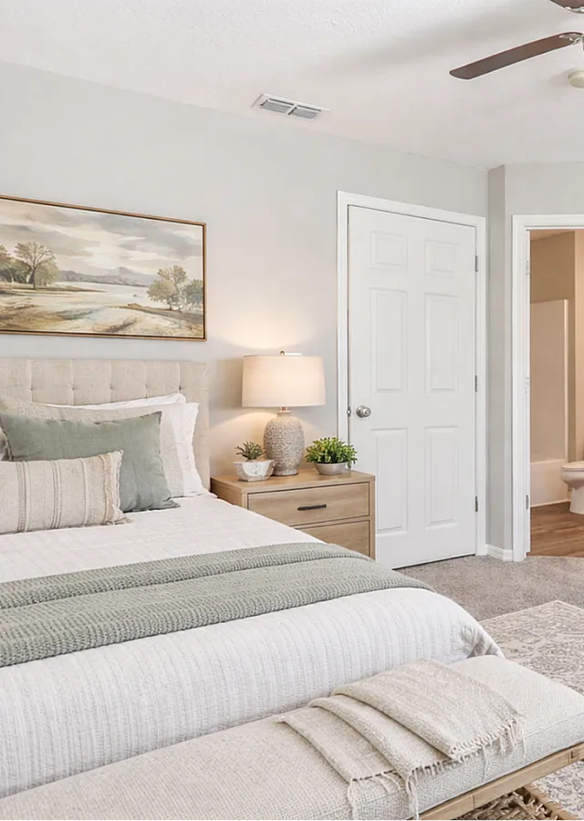 Elegant bedroom with neutral tones, featuring plush bedding, stylish furniture, and soft lighting for a cozy atmosphere.