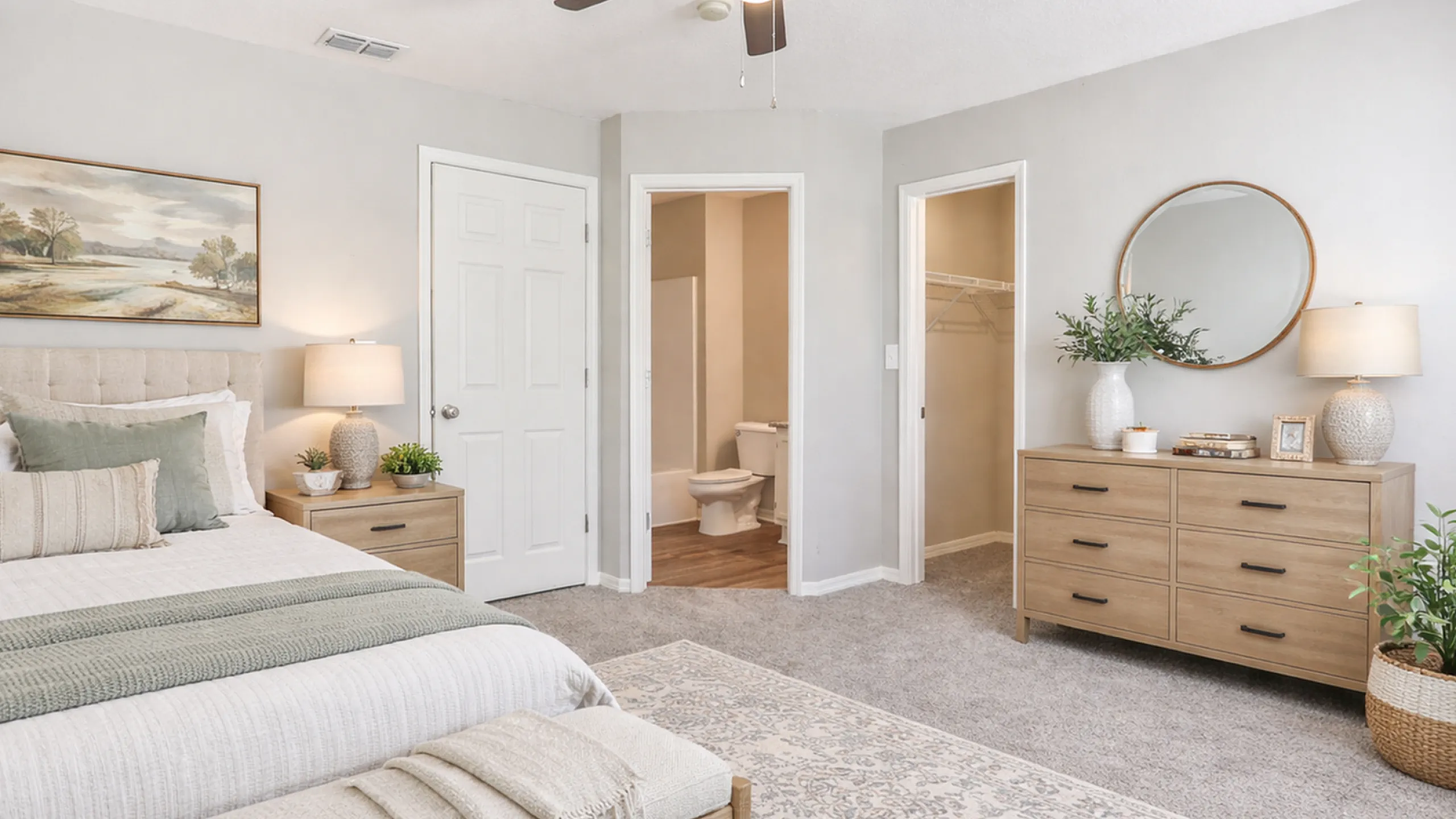 Elegant bedroom with cozy decor featuring a plush bed, stylish wooden furniture, and serene artwork. Highlights include a walk-in closet and en-suite bathroom for ultimate comfort.
