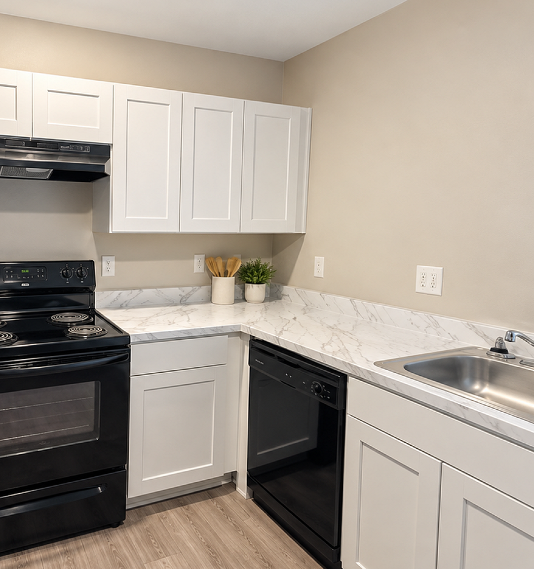 Modern kitchen with sleek white cabinetry, elegant marble countertops, and state-of-the-art black appliances.