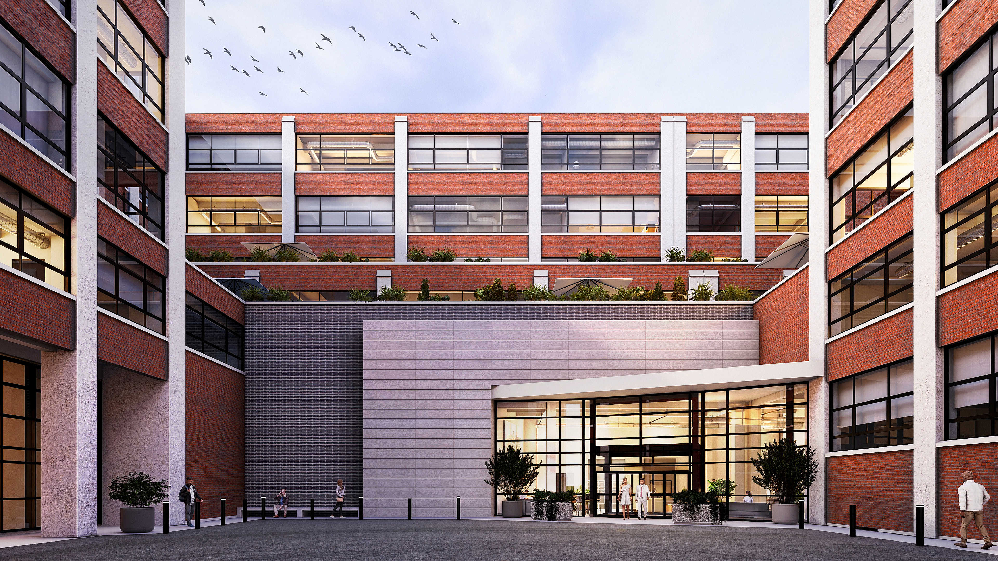 Contemporary brick apartment complex with a spacious courtyard entrance, large windows, and modern design.