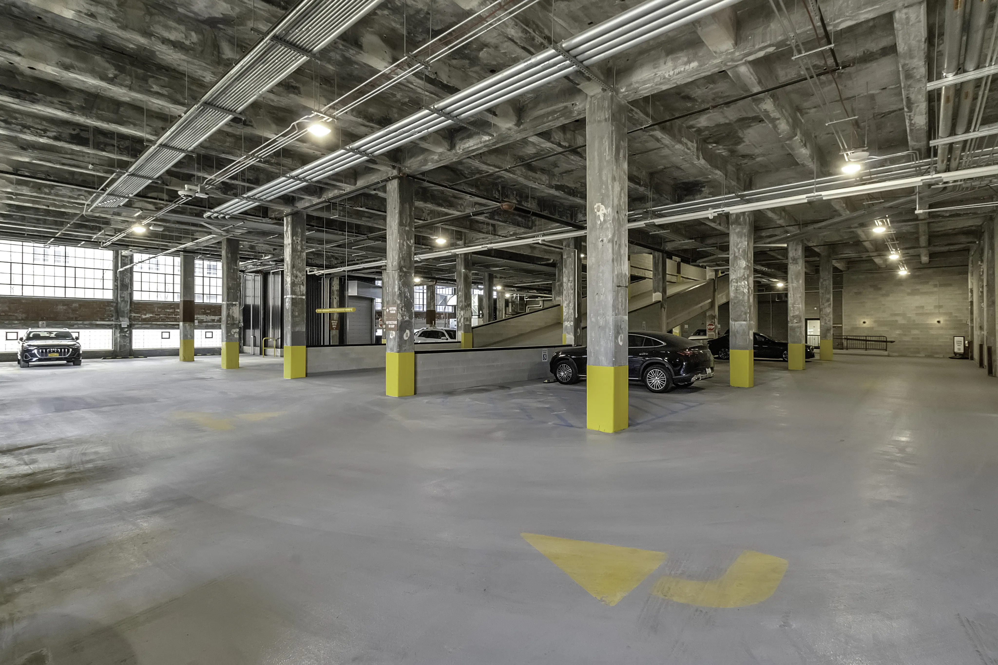 Spacious and modern indoor parking facility with ample natural light and easy navigation.