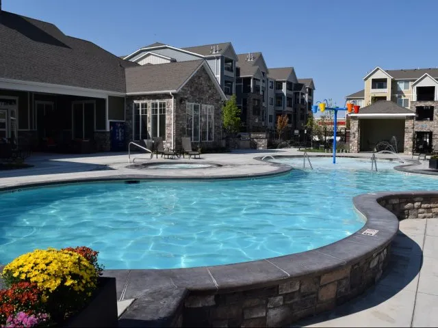 Pool area with hot tub, splash-pad, pool cabana, and 5ft deep swimming pool