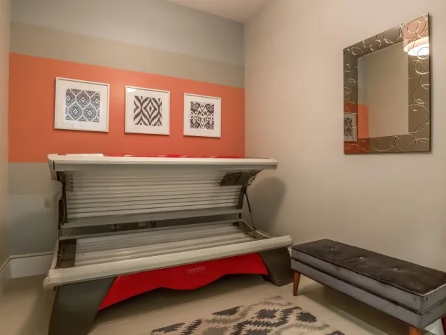 Tanning room with bench and one timed tanning bed
