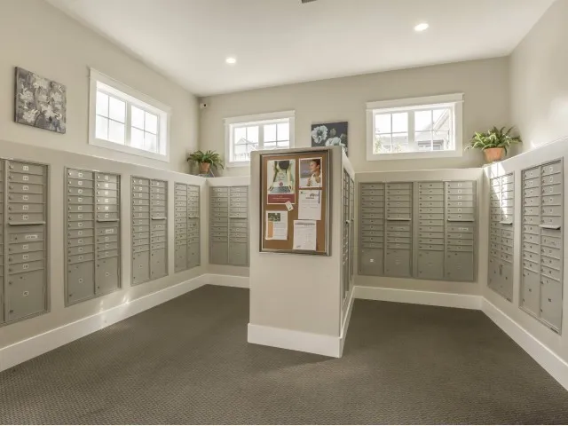 Mail room with with community pin board, all property mailboxes, and multiple security cameras