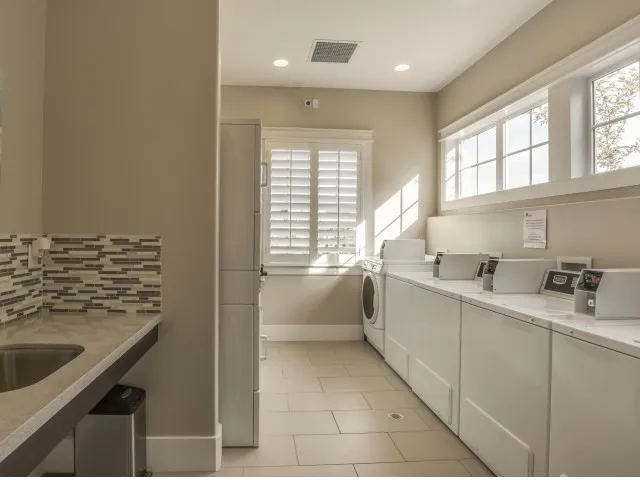 Laundry room with 1 sink, 5 washing machines, and 6 dryers