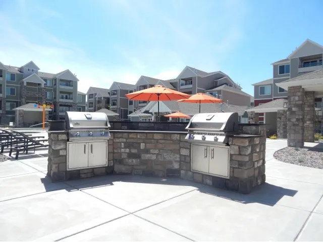 Two stainless steel grills out by the pool area
