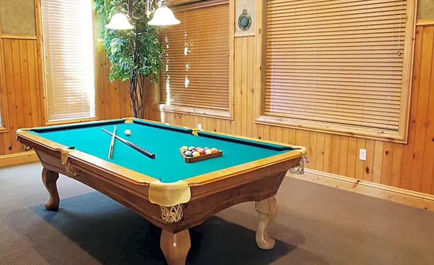 Billiards room with pool table and television