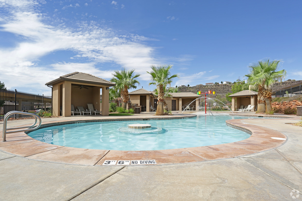 Large 3 feet 6 inch deep pool with splash pad area in front of 4 pool cabanas