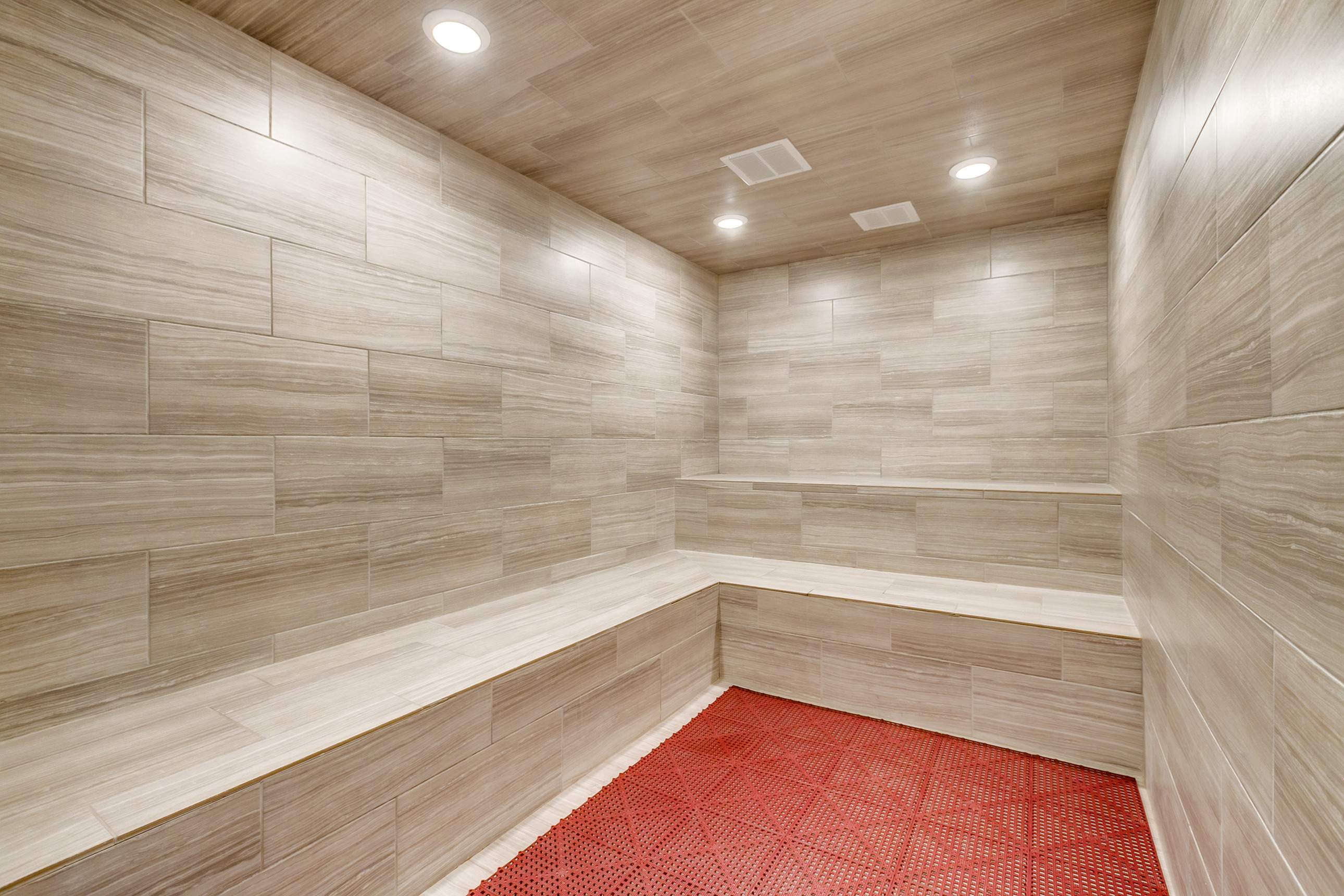 Luxurious sauna room with elegant wood paneling and soft ambient lighting, perfect for relaxation and rejuvenation.