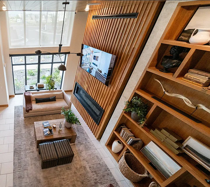 Contemporary living room with high ceilings, elegant decor, and expansive windows, showcasing modern comfort and style.