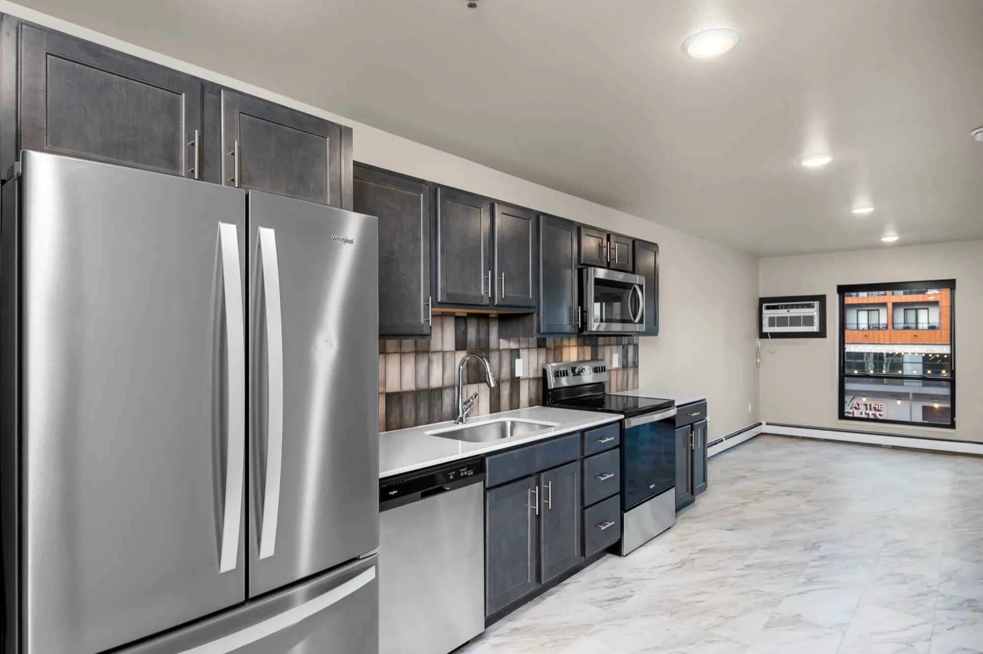 Modern kitchen with stainless steel appliances, sleek cabinetry, and spacious layout, perfect for culinary enthusiasts.