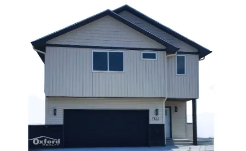 Modern two-story home with sleek design, featuring a spacious garage and elegant exterior finish, ideal for comfortable living.