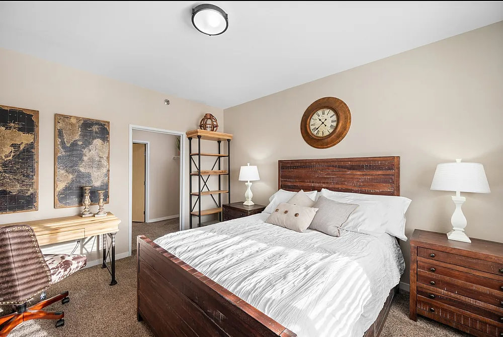Charming bedroom with elegant rustic furniture, featuring a cozy bed, stylish wooden desk, and contemporary decor accents.