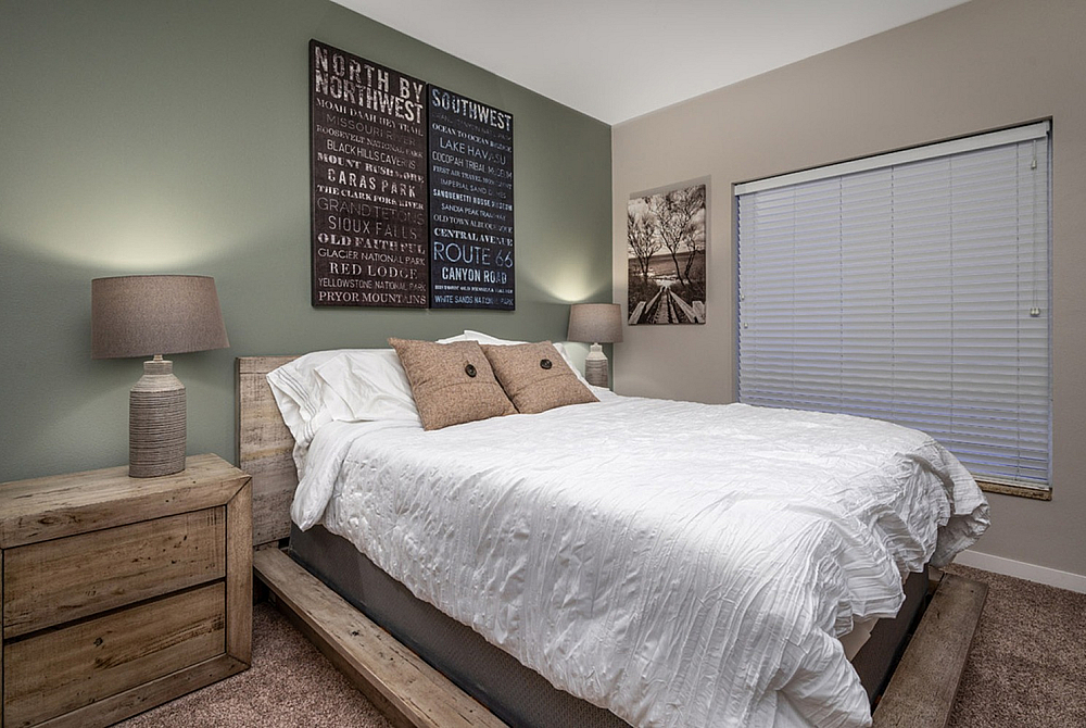 Cozy bedroom with rustic wooden furniture, elegant lamps, and modern decor creating a serene ambiance.