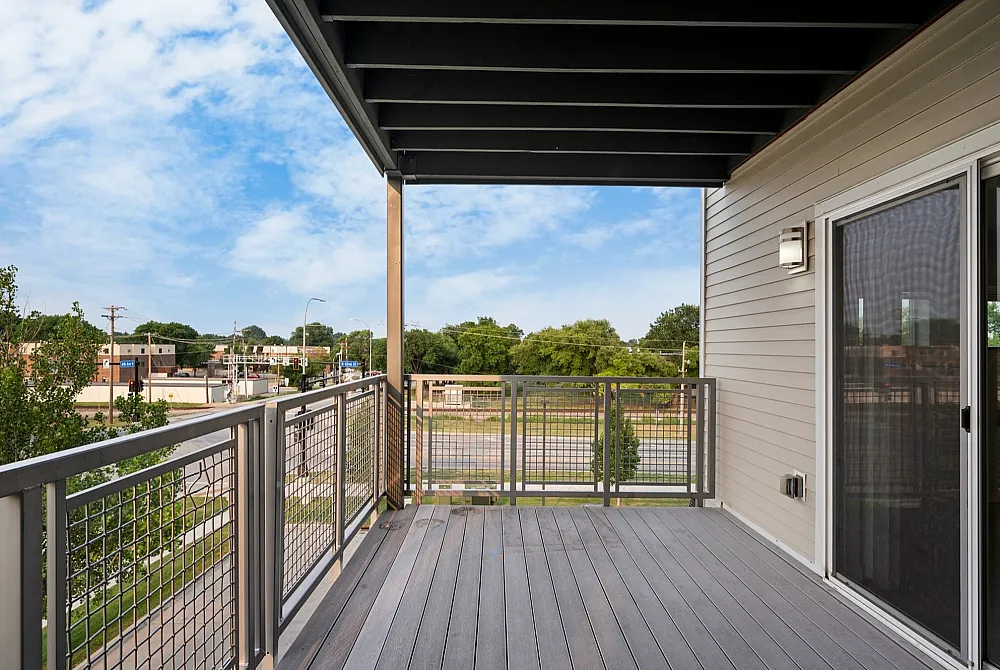 Inviting balcony with modern railing and scenic view, perfect for relaxation and enjoying the outdoors.