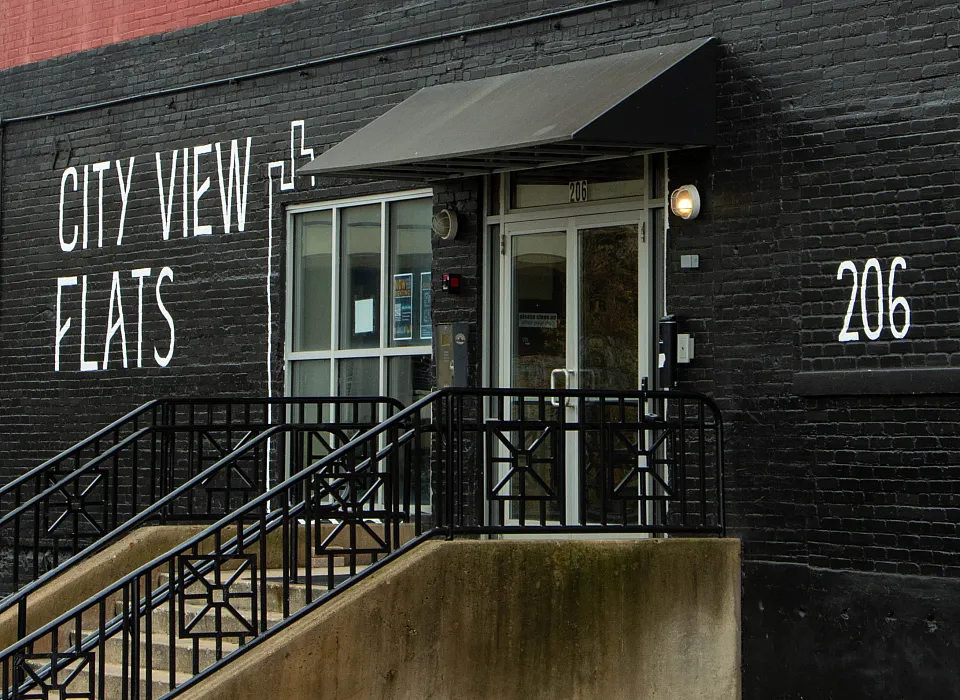 Chic urban apartment exterior with bold brickwork, featuring large windows at City View Flats.